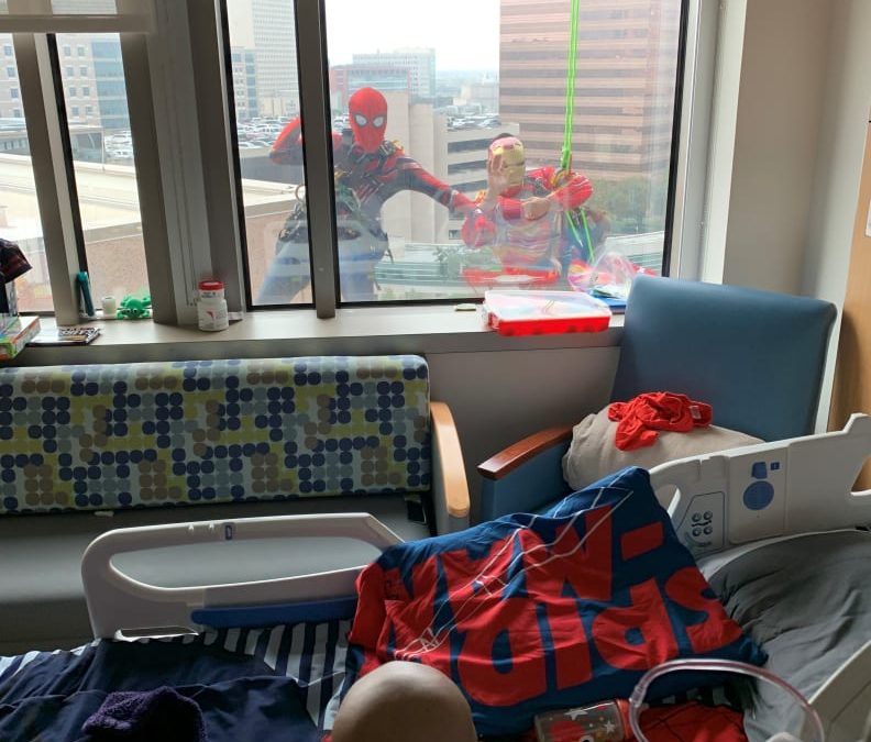 Window-washers disguised as superheroes surprise pediatric cancer patients